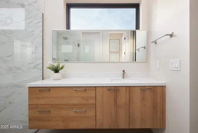a bathroom with a sink a toilet and mirror