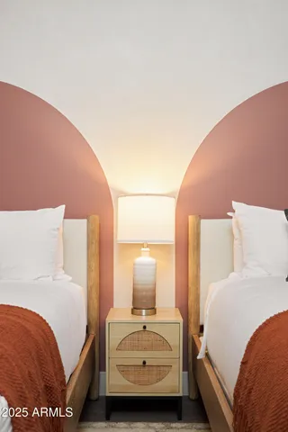 a bedroom with a large bed and a painting on the wall