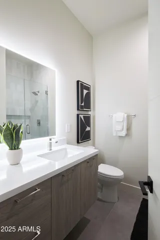 a bedroom with a bed and painting on the wall