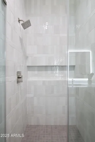 a bathroom with a sink a toilet a mirror and shower