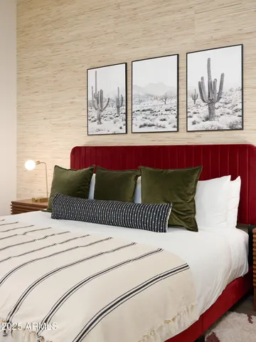 a large bed sitting in a bedroom next to a window