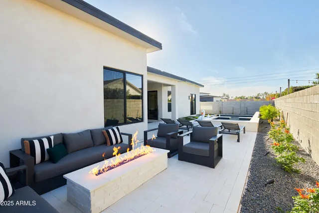 a view of a patio with table and chairs
