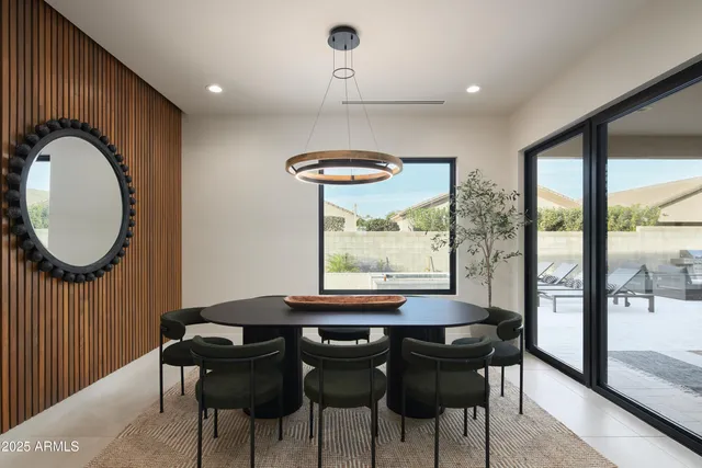 a dining room with furniture and a large window