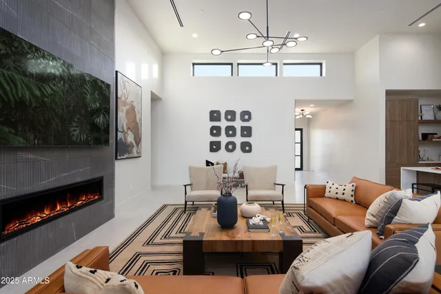 a living room with furniture a flat screen tv and a fireplace