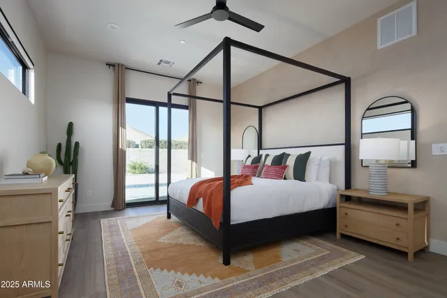 a bedroom with a large bed and a window