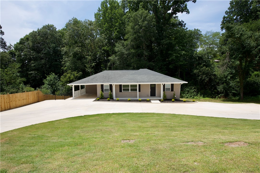 317 Pendleton Road Clemson, SC 29631 - Photo 1 of 36 A well-maintained single-story residence with a wide driveway and ample green space.