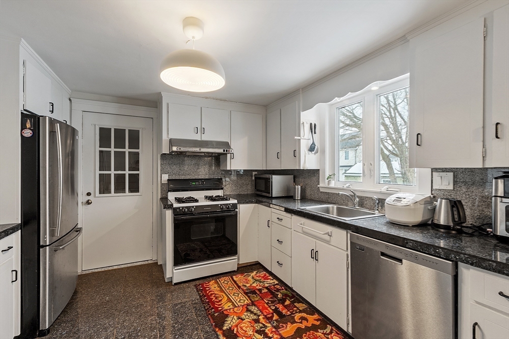 53 Wallace Road Quincy, MA 02169 - Photo 11 of 28 a kitchen with a sink stove and refrigerator
