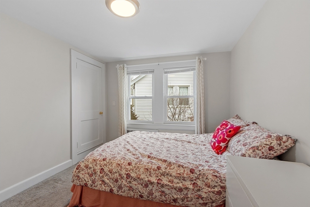 53 Wallace Road Quincy, MA 02169 - Photo 18 of 28 a bedroom with a bed and a window