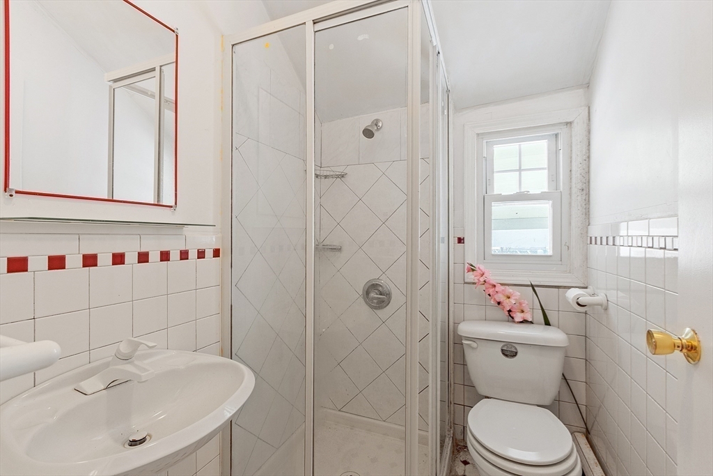 53 Wallace Road Quincy, MA 02169 - Photo 24 of 28 a bathroom with a sink a toilet and shower