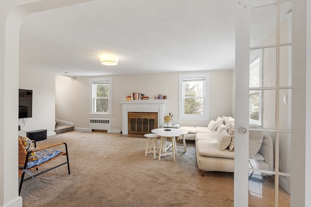 53 Wallace Road Quincy, MA 02169 - Photo 6 of 28 a living room with furniture and a fireplace