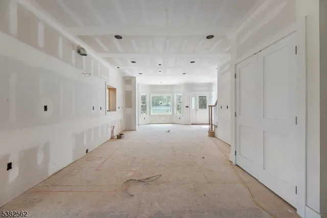 a large white room with windows and pillars in it