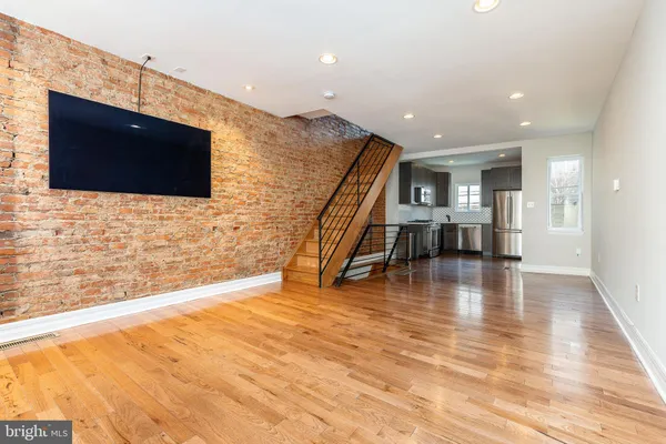 a view of a livingroom with furniture and an empty room