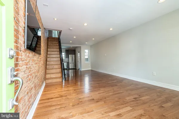 wooden floor in an empty room with a fireplace