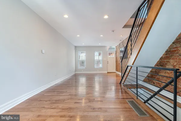 a view of an entryway with wooden floor