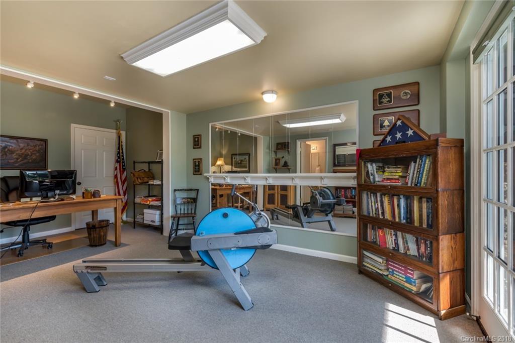 1588 McEntire Road Tryon, NC 28782 - Photo 15 of 27 a living room with furniture a book shelf and a book shelf