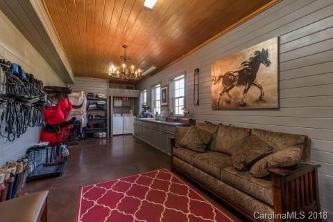 1588 McEntire Road Tryon, NC 28782 - Photo 23 of 27 a living room with furniture and a chandelier