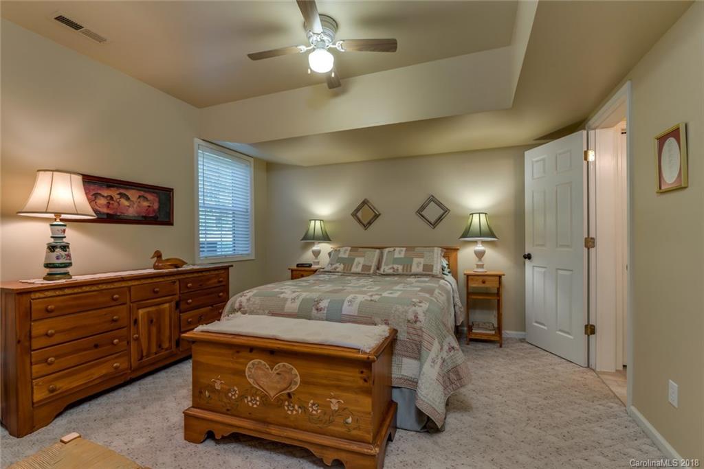 1588 McEntire Road Tryon, NC 28782 - Photo 10 of 27 a spacious bedroom with a bed and a dresser in it