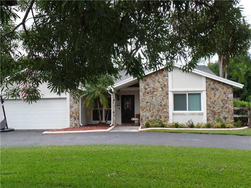 6230 Southwest 186th Way Southwest Ranches, FL 33332 - Photo 1 of 29 a front view of a house with a yard