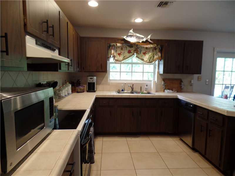 6230 Southwest 186th Way Southwest Ranches, FL 33332 - Photo 8 of 29 a kitchen with a sink a stove and cabinets