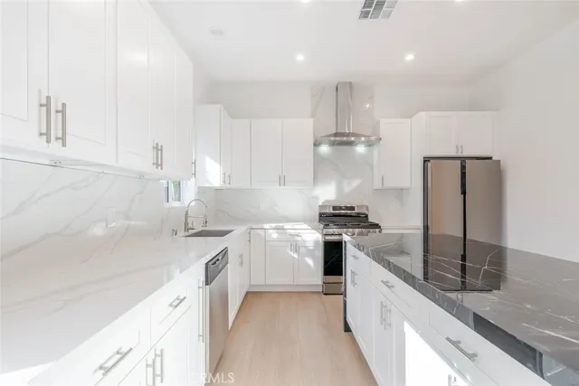 a kitchen with a sink stainless steel appliances and cabinets