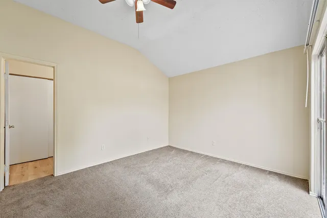 an empty room with a empty space and windows