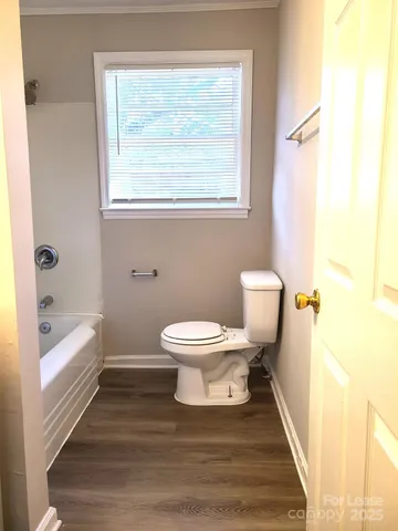 a bathroom with a toilet and a bathtub