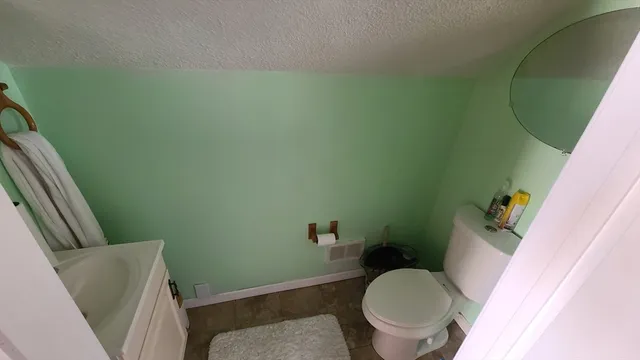 a white toilet sitting next to a sink