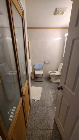 a bathroom with a toilet and a shower
