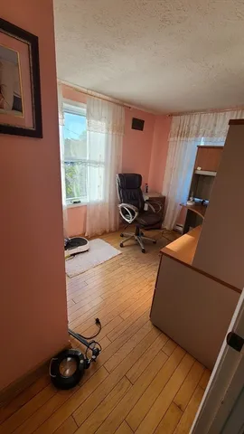 a livingroom with workspace and a window