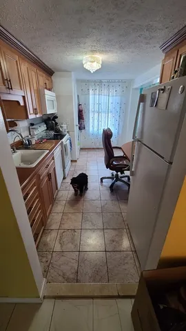 a kitchen with a sink and a stove top oven