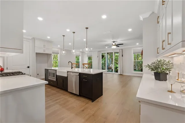 a large kitchen with kitchen island a sink stainless steel appliances and cabinets