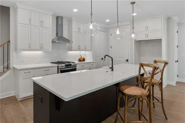 a kitchen with a sink a table and chairs in it