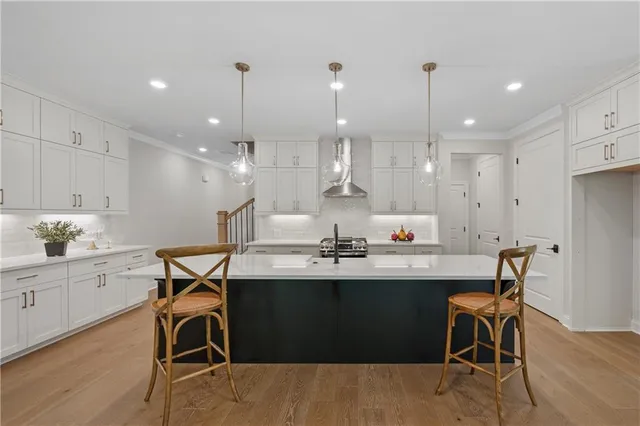 a kitchen with a table chairs sink and cabinets