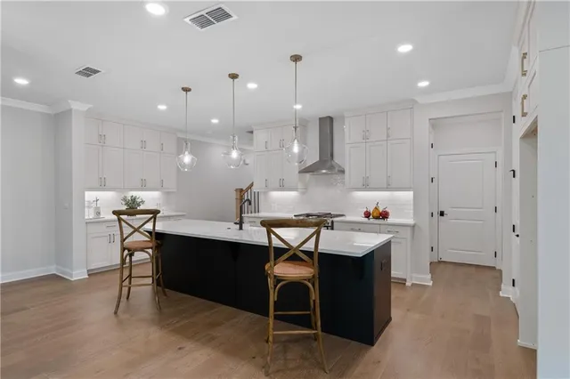 a kitchen with kitchen island a sink table and chairs