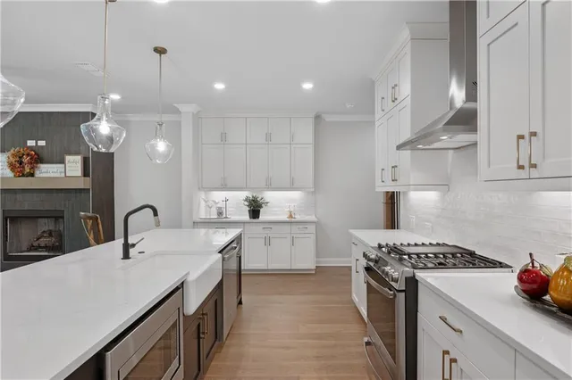 a kitchen with a sink stove and cabinets