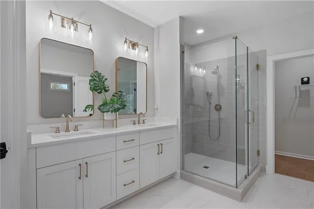 a bathroom with a shower tub double sink and mirror