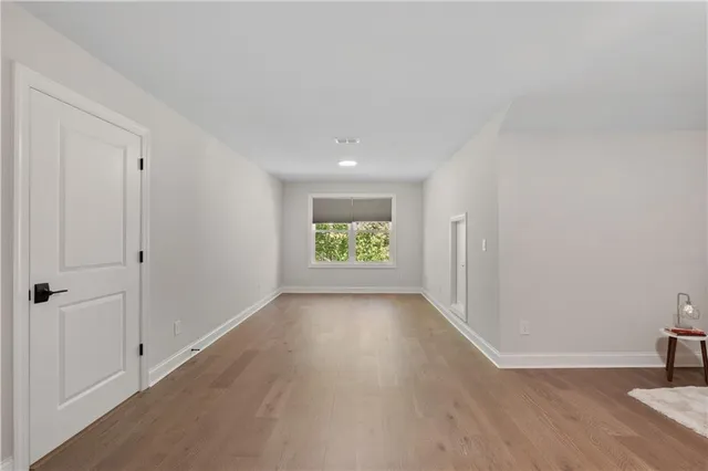 a view of room with window and wooden floor