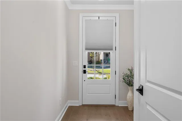 a view of an entryway with wooden floor