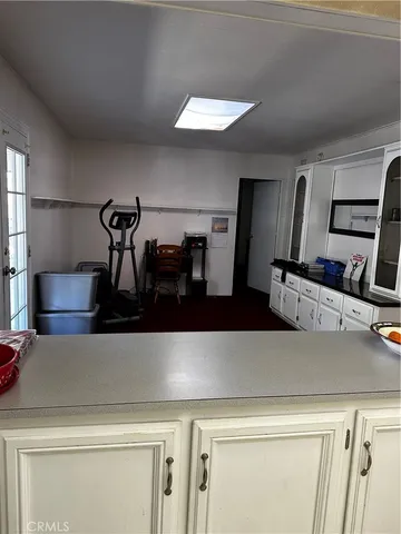 a living room with furniture and kitchen view