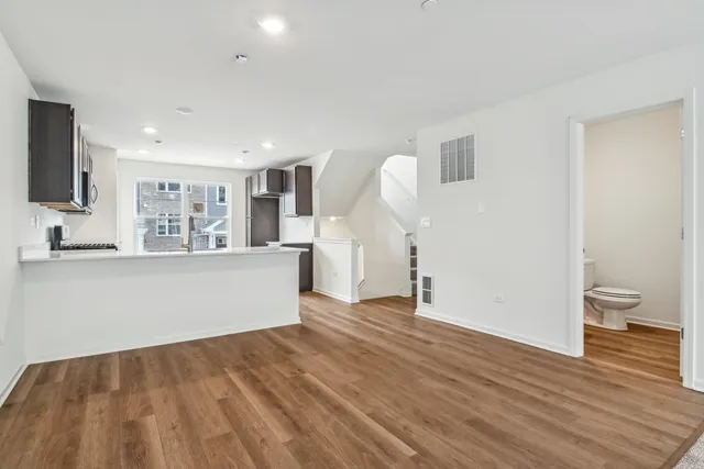 a view of a kitchen with wooden floor and a sink