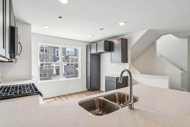 a kitchen with sink refrigerator and washing machine