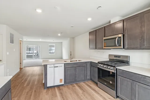 a kitchen with stainless steel appliances granite countertop a stove and a sink