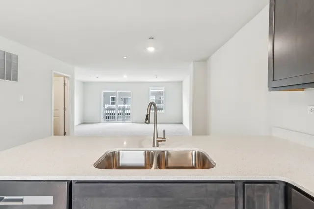 a kitchen with kitchen island a sink and a refrigerator