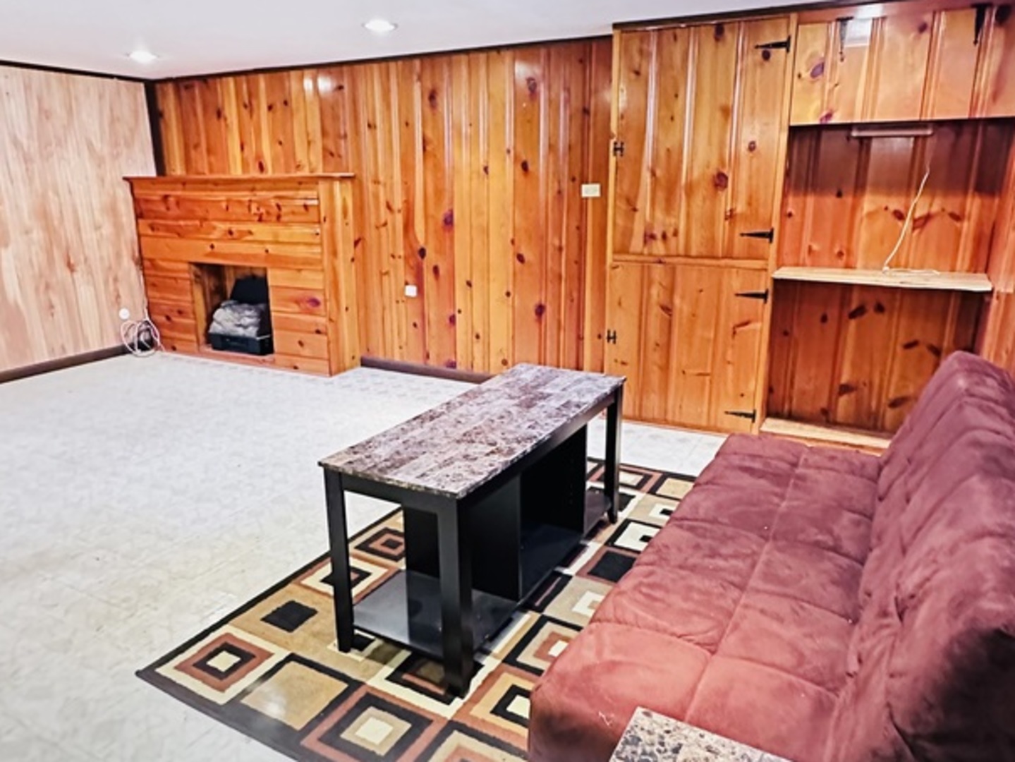 4641 Butterfield Road Hillside, IL 60162 - Photo 53 of 57 a living room with a bed and a table