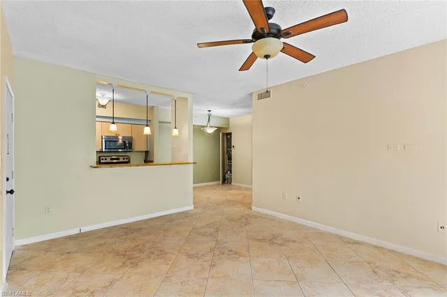 a view of a livingroom with a ceiling fan and window