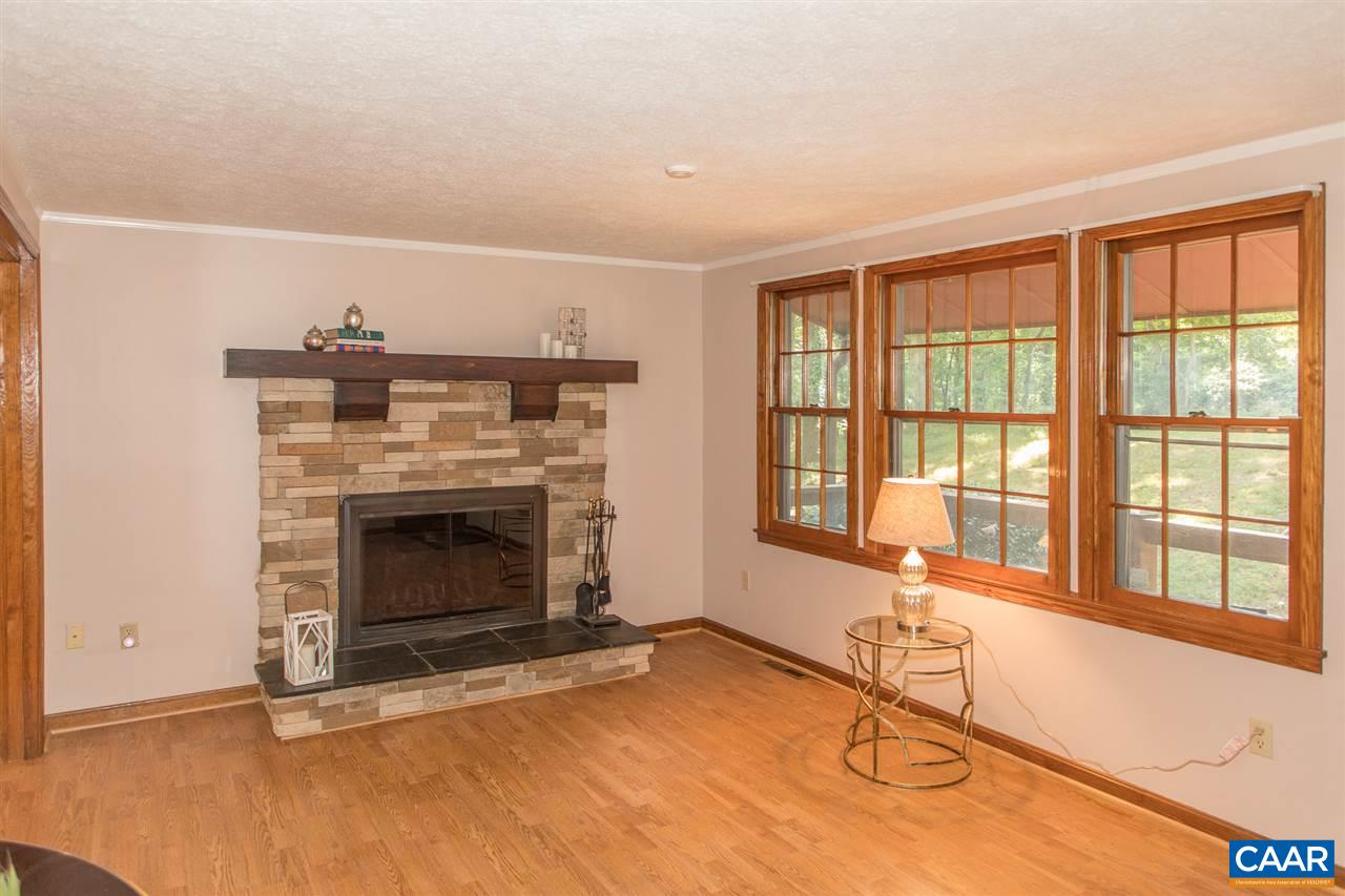 824 Dry Bridge Road Charlottesville, VA 22903 - Photo 8 of 43 a living room with furniture a flat screen tv and a fireplace