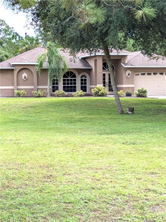 2910 2nd Street Northeast Naples, FL 34120 - Photo 1 of 9 a front view of a house with a garden
