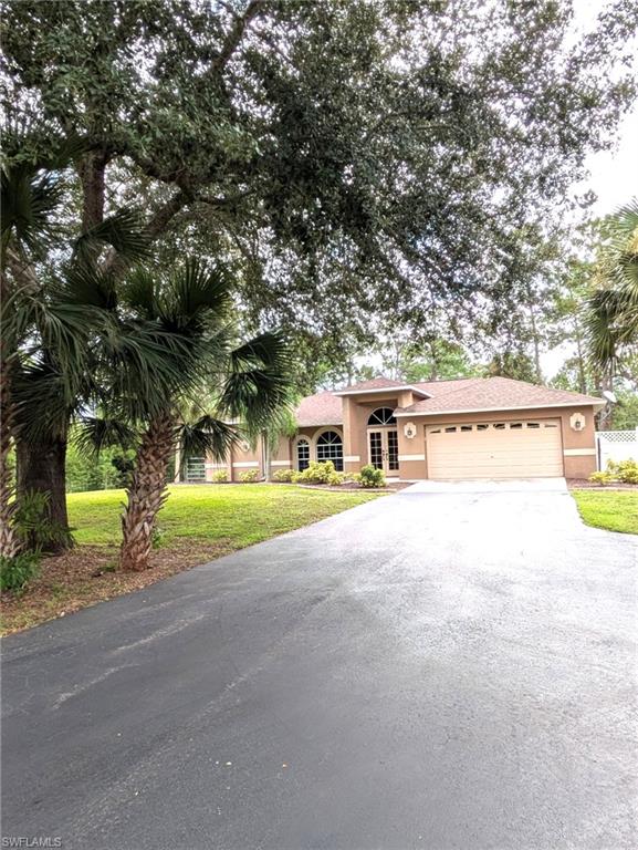 2910 2nd Street Northeast Naples, FL 34120 - Photo 2 of 9 a view of house with outdoor space and sitting area