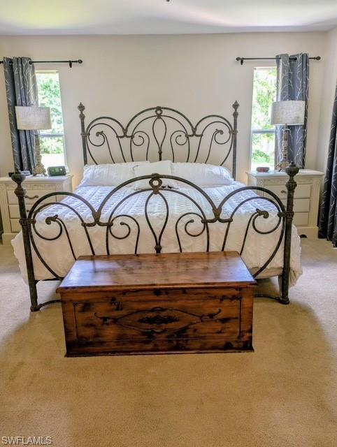 2910 2nd Street Northeast Naples, FL 34120 - Photo 6 of 9 a bedroom with a bed and a table in it