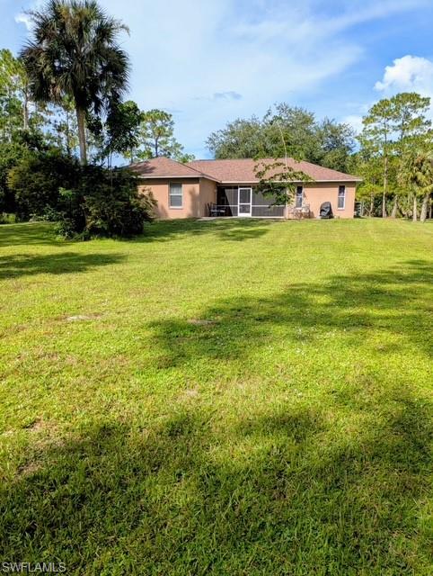 2910 2nd Street Northeast Naples, FL 34120 - Photo 9 of 9 a view of a house with a big yard and large trees